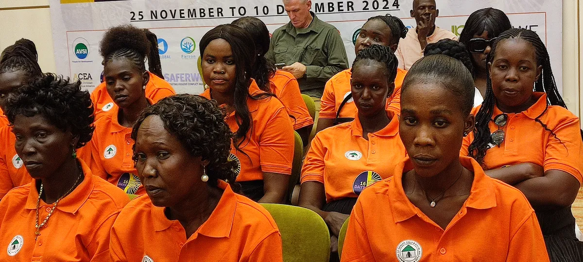 Women in orange Women Frontline Doctors shirts at the 16 Days of Activism against Gender-Based Violence event, 2024